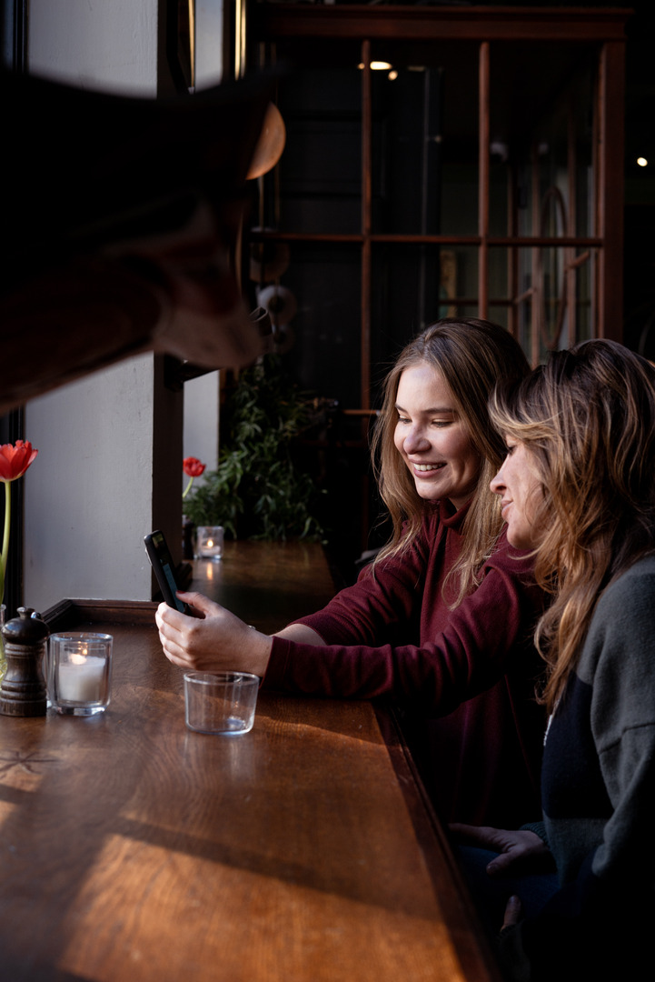 Members sharing a moment at a cafe window